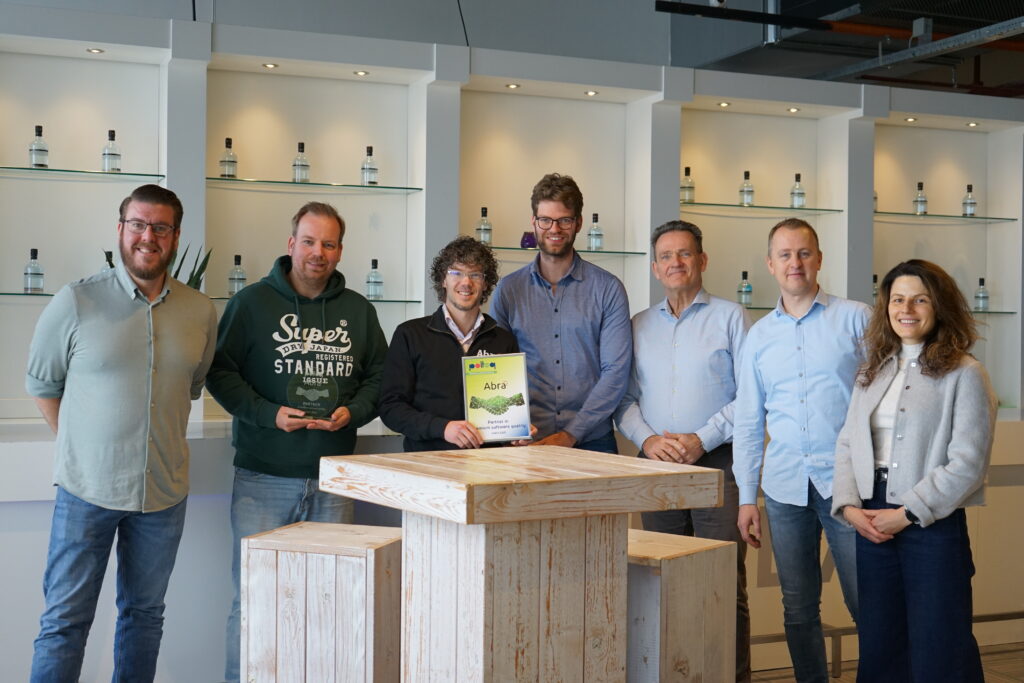 Polteq employees and Abra employees pose for a partnership photo.