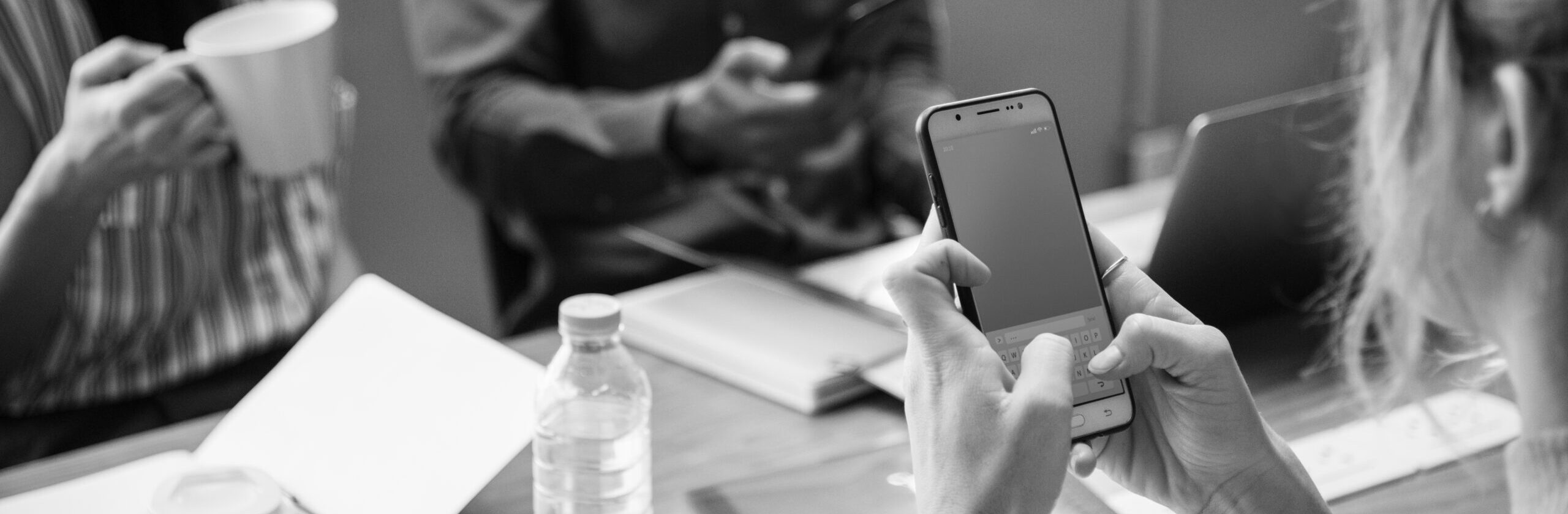 Woman playing in her phone in a meeting